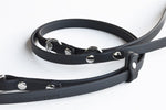 Close up of Black Brahma 8-Way Lead in Medium half-inch width on white background