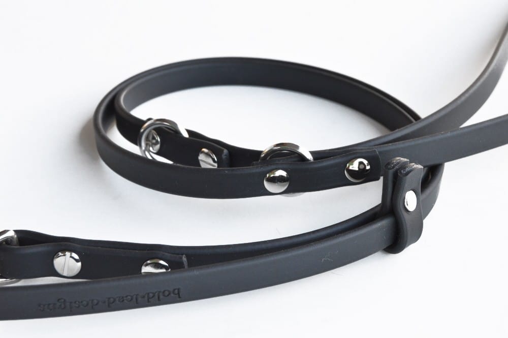 Close up of Black Brahma 8-Way Lead in Medium half-inch width on white background