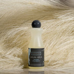 Bottle of Eucalan delicate detergent on a textured beige background