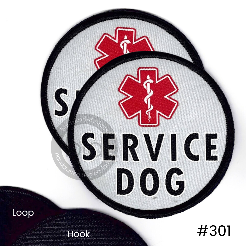 Two 'Service Dog' patches with a red caduceus on a white background and a sample of loop and hook Velcro backing