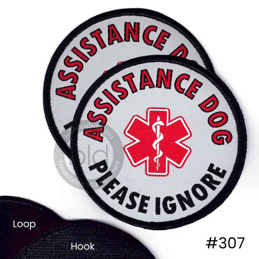 'Assistance dog please ignore' patches with red star of life symbol on a white background