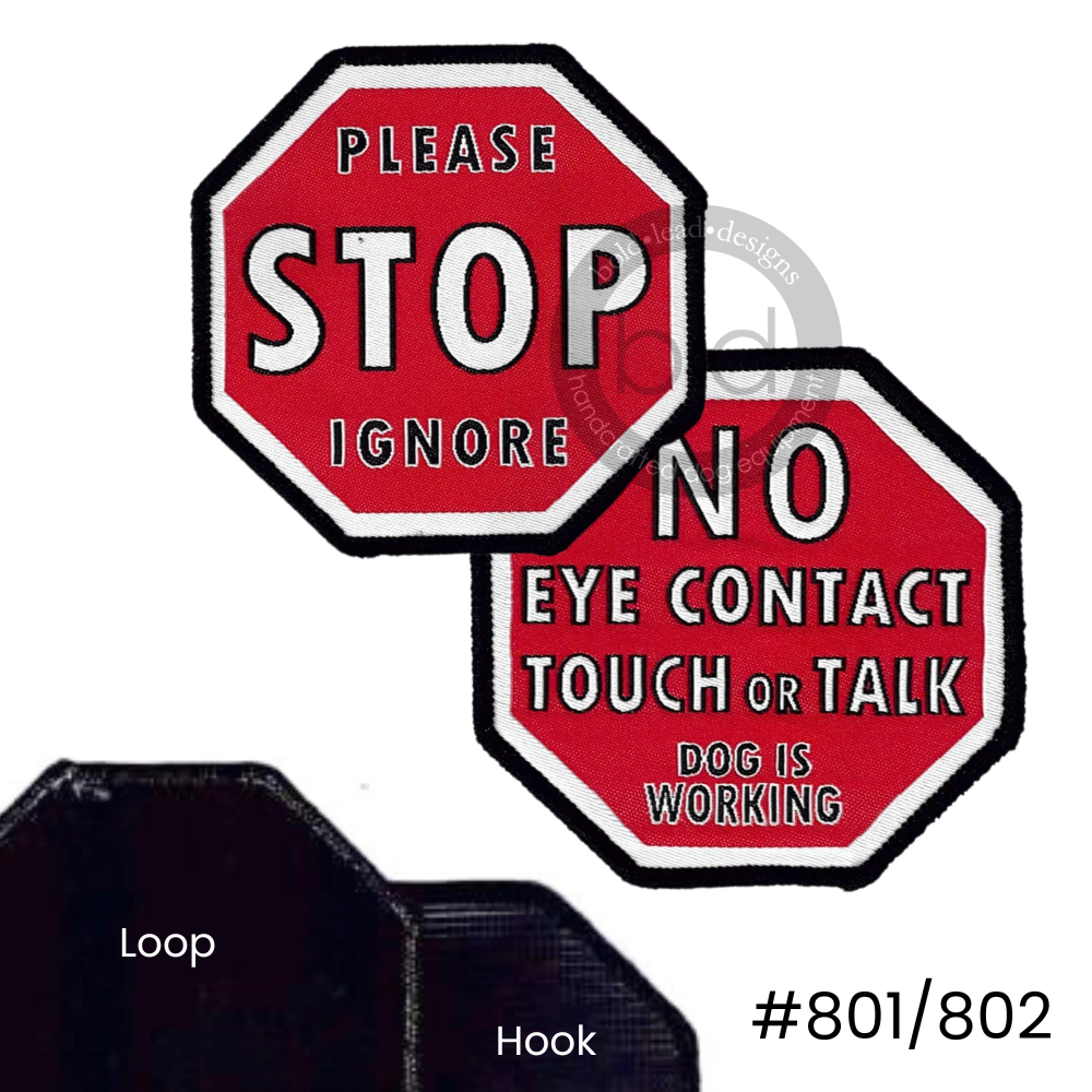 Two red stop sign-shaped badges, one reads 'please stop ignore,' and the other says 'no eye contact touch or talk dog is working' 