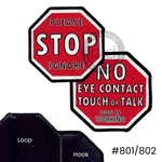 Two red stop sign-shaped badges, one reads 'please stop ignore,' and the other says 'no eye contact touch or talk dog is working' 