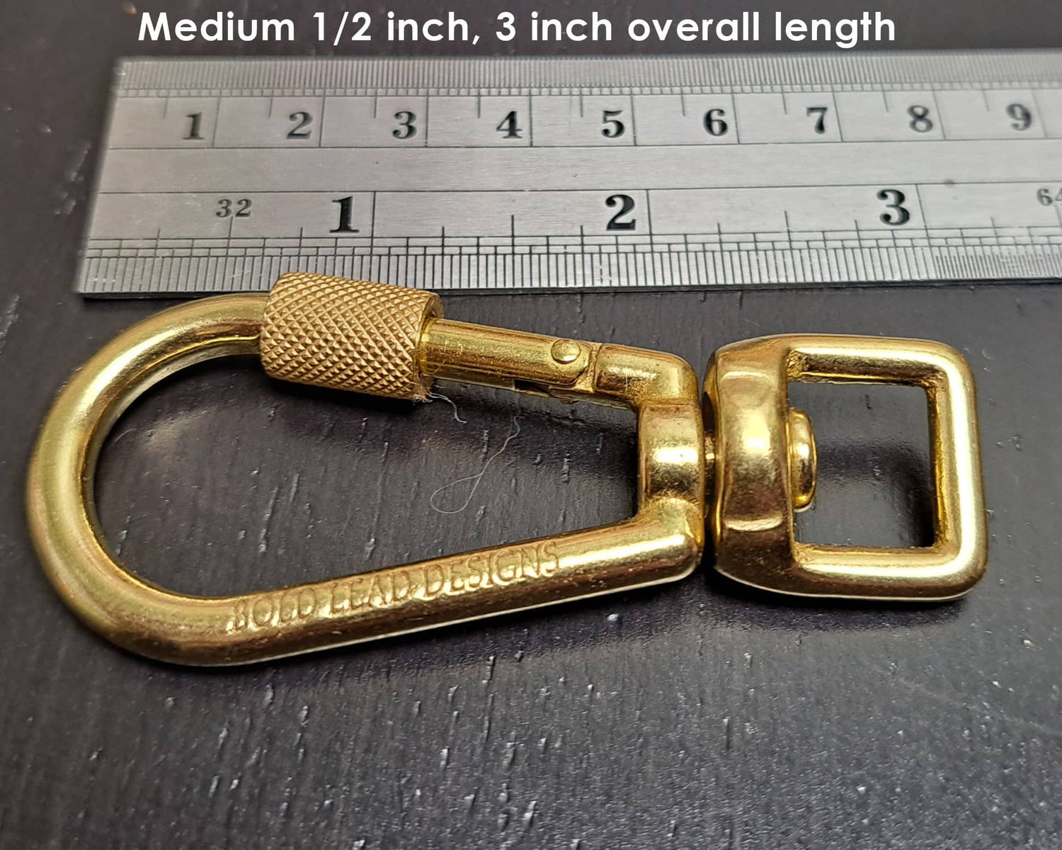 Medium 1/2 inch locking carabiner snap next to ruler for sale