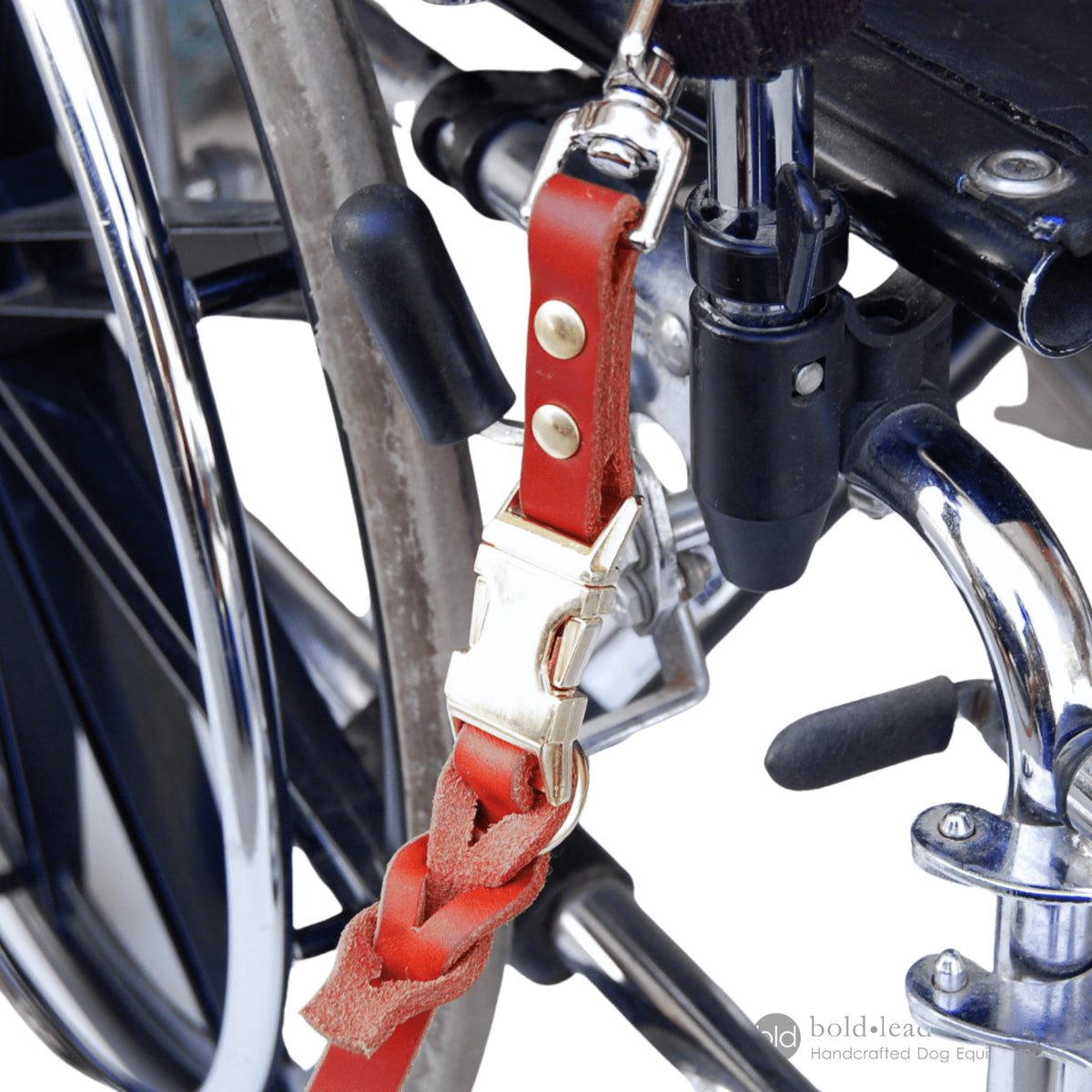 closeup of Tan leather Quick Release Wheelchair leash attachment on a manual wheelchair
