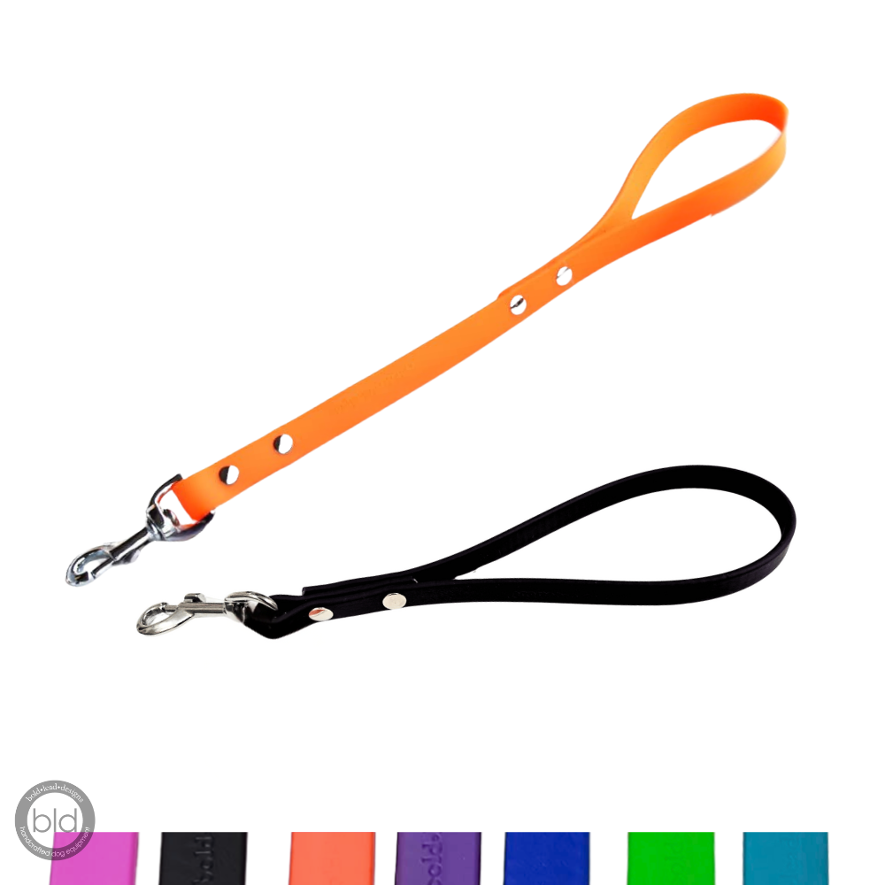 Orange short leash and black traffic lead on white background