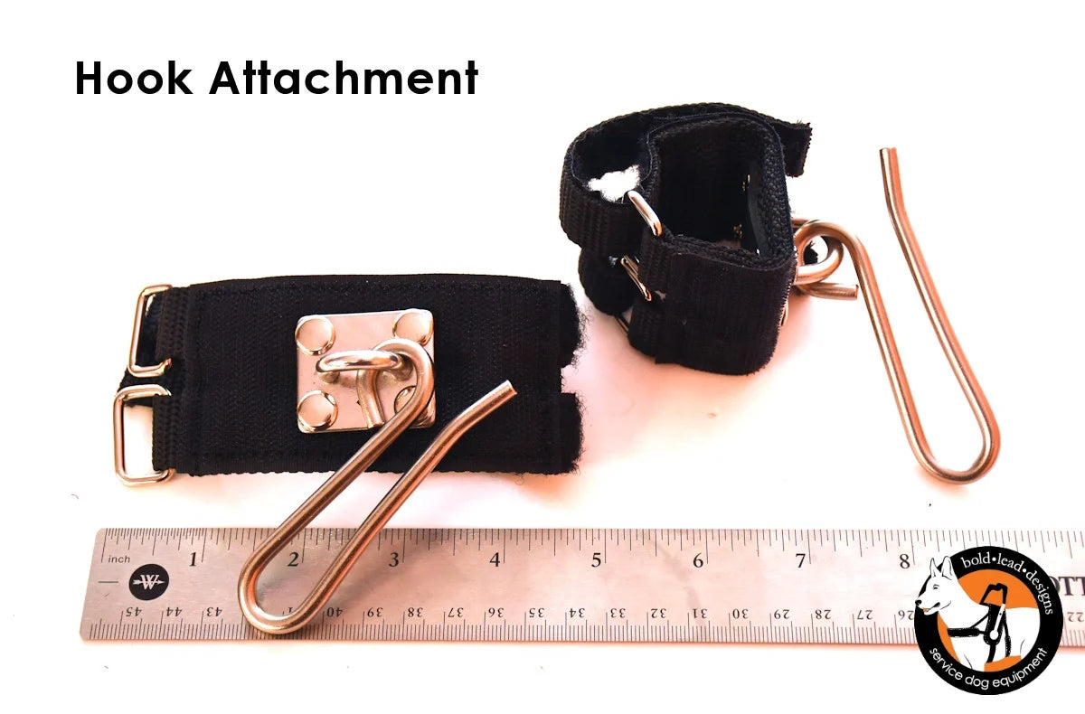 Wheelchair hook attachment and ruler for scale on a white background