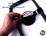 Hand attaching a leash wrap to a banner badge converter with text on a white background.