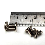 1/4 inch Chicago screws with a ruler for scale on a white background