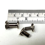 3/8 inch Chicago screws with a ruler for scale on a white background