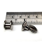 3/16 inch Chicago screw "shorties" with a ruler for scale on a white background